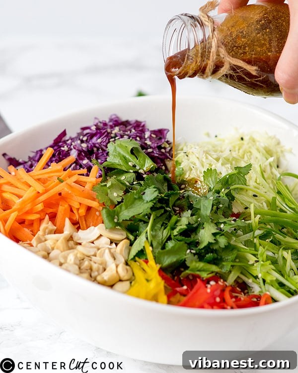 Fresh and Crunchy Asian Coleslaw Close-up view of fresh Asian Coleslaw, highlighting its crunchy vegetables and rich dressing.