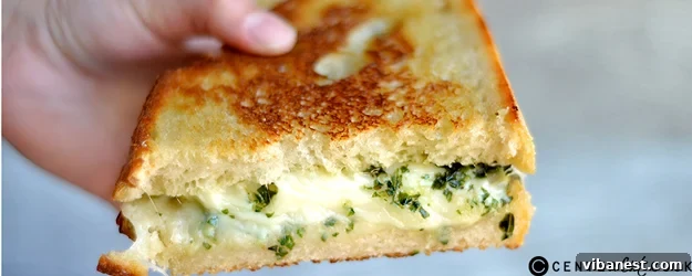 Pesto Artichoke Grilled Cheese Sandwich on a cutting board, ready to be served