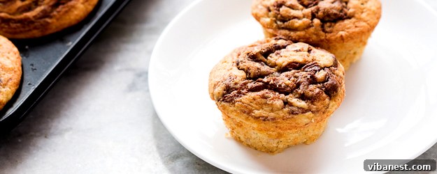 Delicious Nutella Swirled Banana Muffins, close-up shot of a freshly baked muffin with visible Nutella swirl and banana chunks