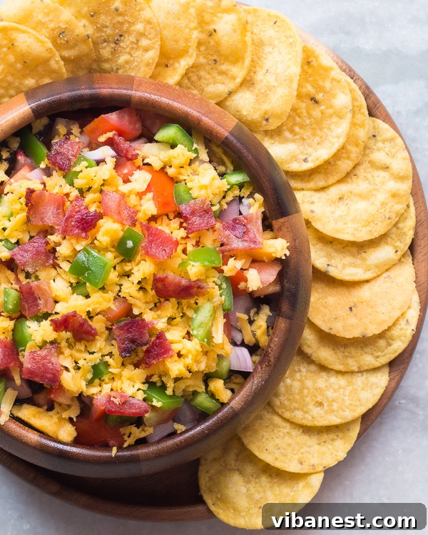 bbq-bacon-ranch-dip-2.jpg Close-up of the creamy, layered BBQ Bacon Ranch Dip with visible bacon and vegetables.