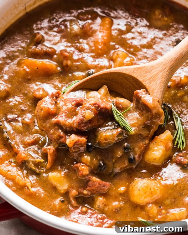 Rustic Beef Stew Bowl Close-up of a rustic bowl of rosemary garlic beef stew with bread