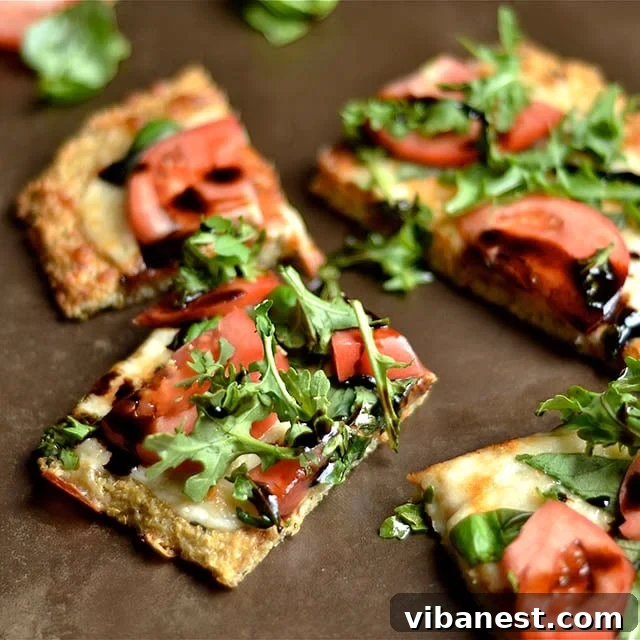 Finished Caprese Quinoa Pizza sliced on a wooden board
