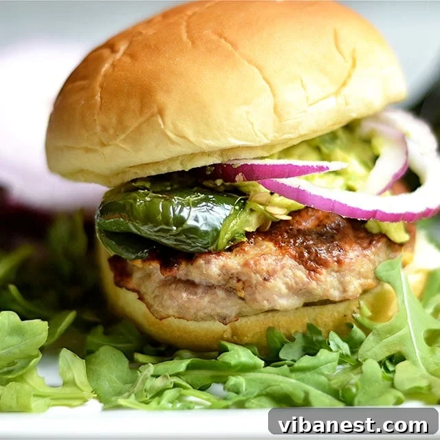 Plated Johnsonville sausage burger with grilled poblano peppers and a side of fresh guacamole, ready to eat.