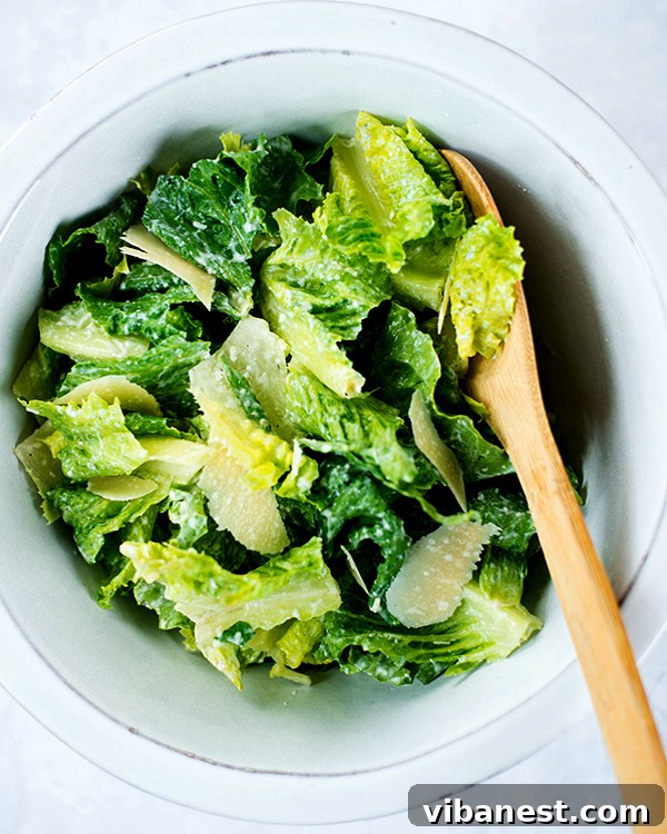 homemade-caesar-dressing-2.jpg Freshly made homemade Caesar dressing in a bowl with a spoon