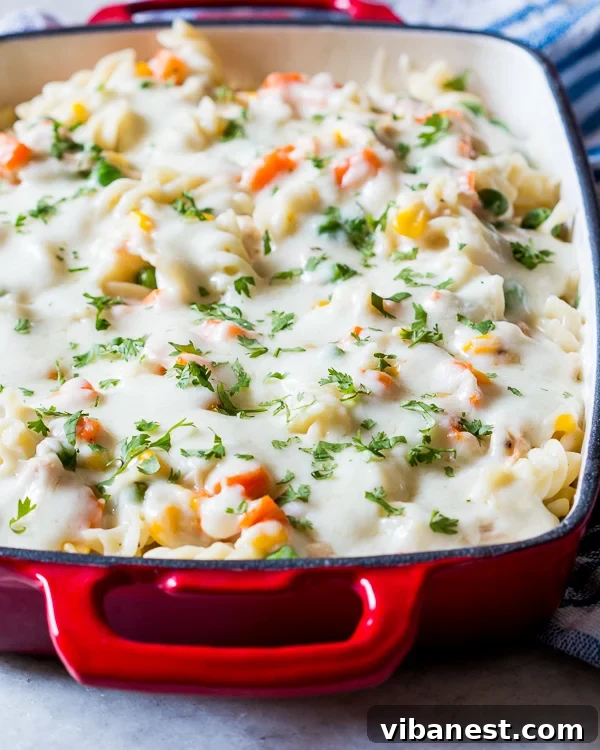 Creamy Chicken Pot Pie Noodle Casserole Scoop Close-up of creamy chicken pot pie noodle casserole with a spoon taking a scoop