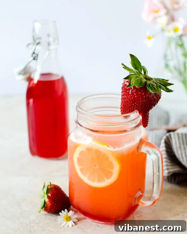 Homemade Strawberry Simple Syrup Close-up of freshly made strawberry simple syrup, a key ingredient for delicious homemade lemonade, showing the rich red color.