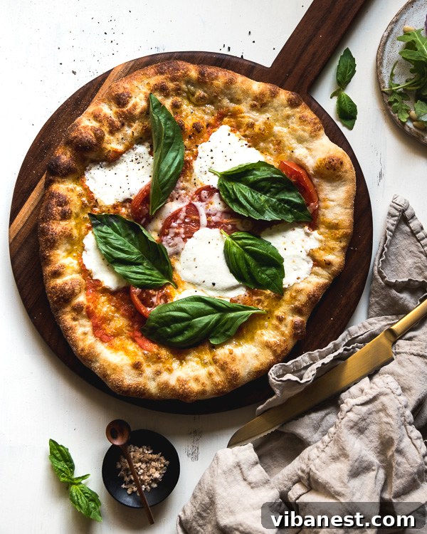 Close-up of a freshly baked Margherita pizza with bubbly cheese and charred crust edges