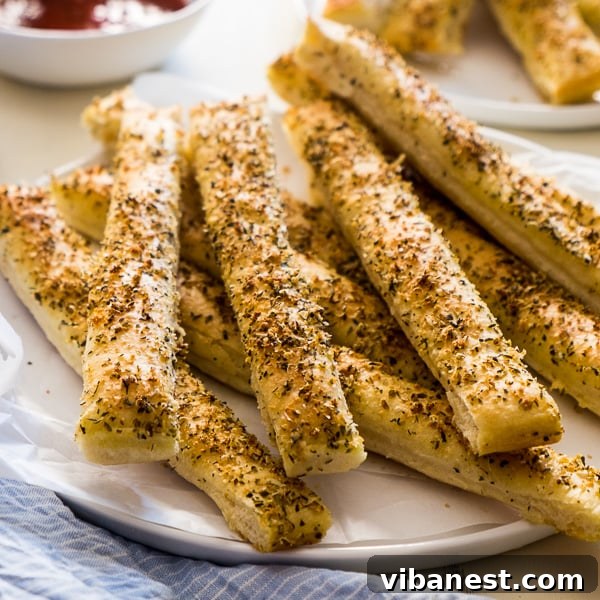 Close-up of freshly cut Pizza Hut style breadsticks before baking, ready for topping