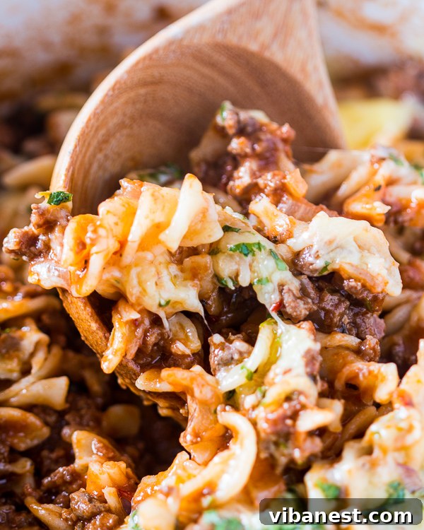 Close-up shot of Skillet Cheeseburger Pasta Casserole with visible melted cheese and herbs