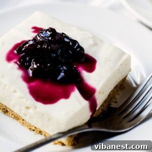 no bake cheesecake bar on a plate with a fork