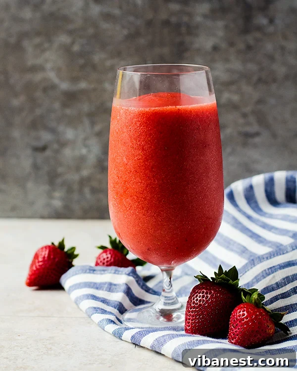 Delicious Virgin Strawberry Daiquiri A vibrant glass of virgin strawberry daiquiri, perfectly blended and garnished with fresh strawberries, embodying refreshing summer vibes.