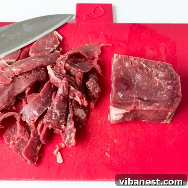 Perfectly Sliced Ribeye for Cheesesteak Close-up of thinly sliced raw ribeye steak, ready for cooking