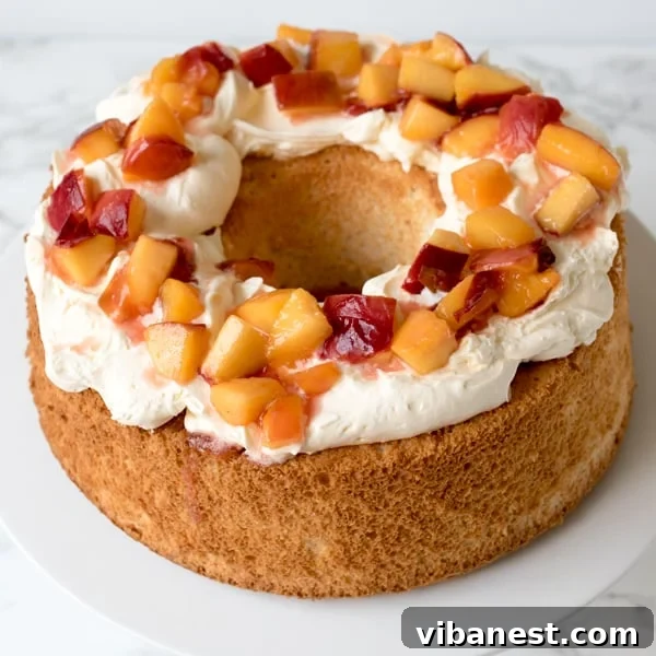 Angel Food Cake Recipe Presentation A vibrant Angel Food Cake with poached peaches and cream, presented beautifully.