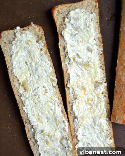 artichoke-dip-stuffed-garlic-bread-4.jpg Freshly Baked Artichoke Dip Stuffed Garlic Bread, Ready to Serve