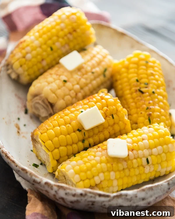Slow Cooker Corn on the Cob - A simple and delicious side dish. Perfectly cooked slow cooker corn on the cob with butter, ready to serve.