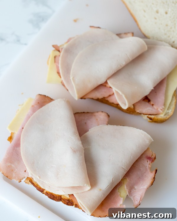 Perfectly Fried Monte Cristo Monte Cristo sandwich cut in half, revealing the layers and perfectly melted cheese