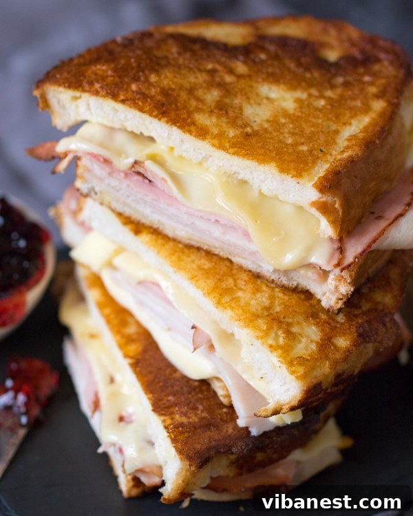 Monte Cristo with Jelly and Powdered Sugar Monte Cristo sandwich served with a dusting of powdered sugar and a side of red currant jelly