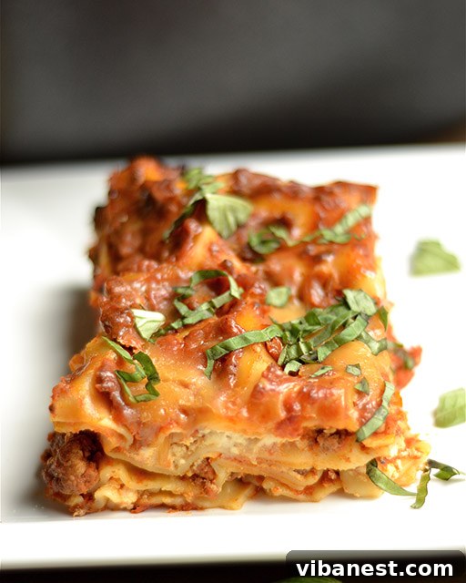Perfectly Layered Slow Cooker Lasagna Close-up of slow cooker lasagna, showcasing the layers of meat sauce, cheese, and noodles