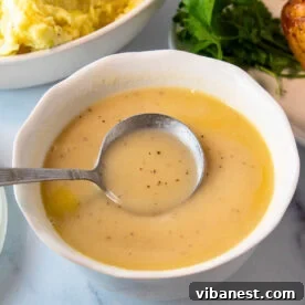 Top-Tier Thanksgiving Side Dishes 3 Rich, smooth, homemade turkey gravy in a gravy boat, ready to be poured over turkey and mashed potatoes.