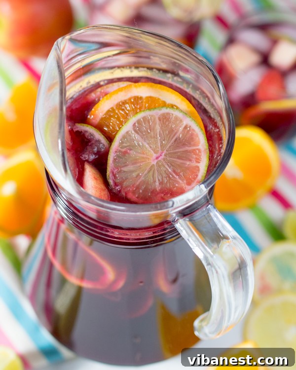 refreshing-virgin-sangria Vibrant pitcher of virgin sangria with sliced citrus and berries, ready to be poured