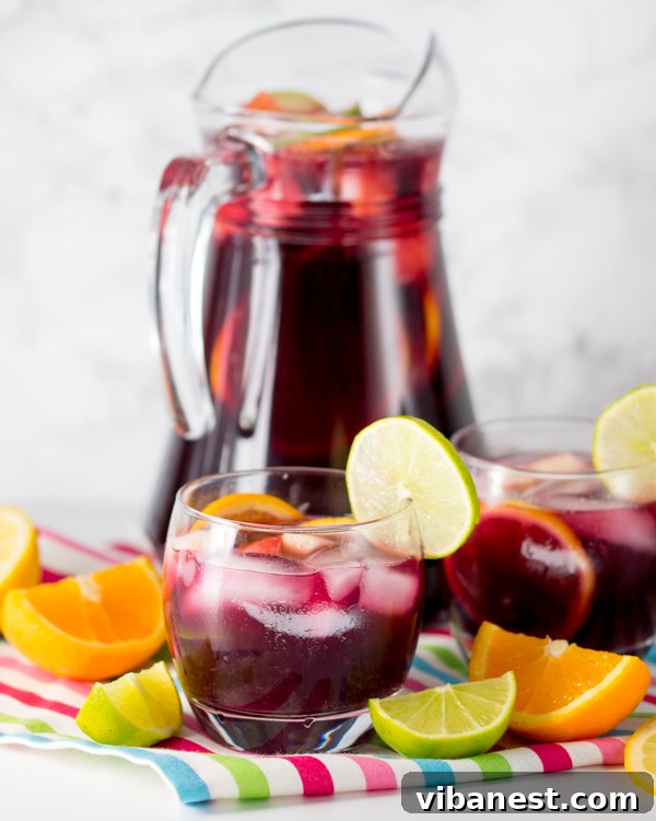 kid-friendly-sangria Happy child holding a small glass of virgin sangria at a festive outdoor gathering