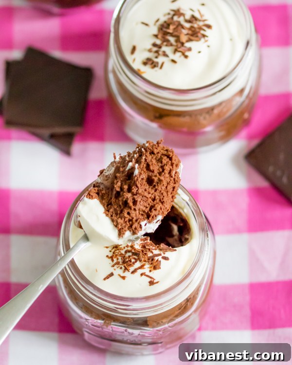 chocolate-mousse-whipped-cream-4.jpg Several glasses of chocolate mousse, ready to be served, showcasing the elegant presentation