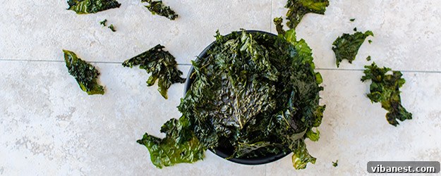 Crispy homemade kale chips artfully arranged on a serving plate