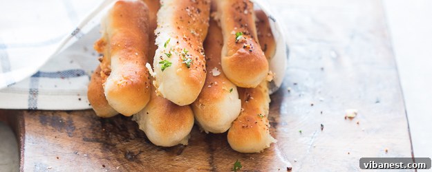 Golden brown cheese stuffed garlic breadsticks on a baking sheet, ready to be served
