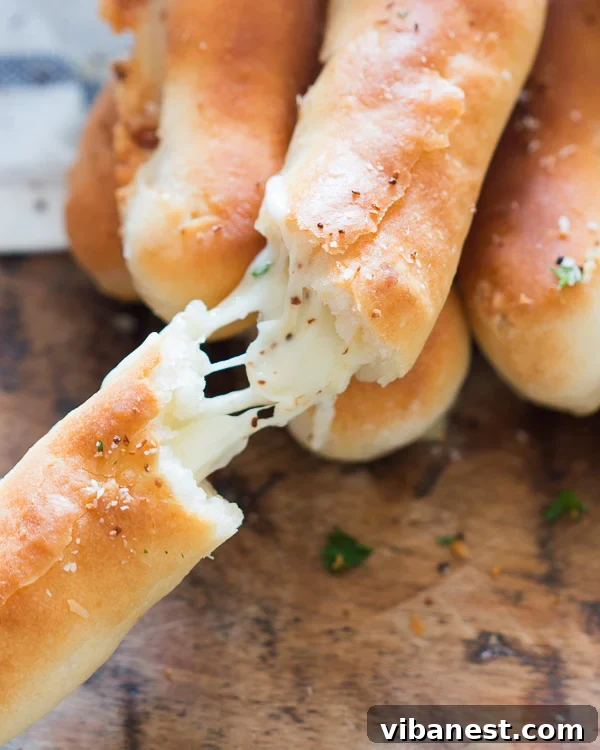 cheese-stuffed-garlic-breadsticks-2.jpg Close-up of freshly baked cheese stuffed garlic breadsticks, showing the golden crust and soft interior