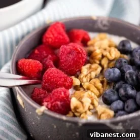 Crafting the Perfect Bowl of Oatmeal 3 A bowl of microwave oatmeal topped with fresh berries and granola, ready for a quick breakfast.