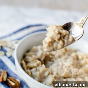 A spoonful of creamy oatmeal being pulled from a bowl, highlighting its rich texture.