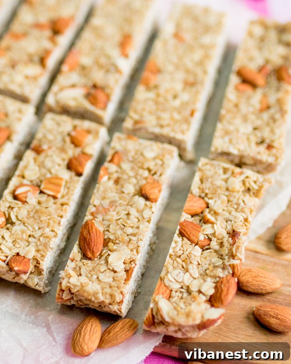 No-Bake Granola Bar Mixture Being Pressed Firmly Perfectly pressed no-bake granola bar slab in a baking tin
