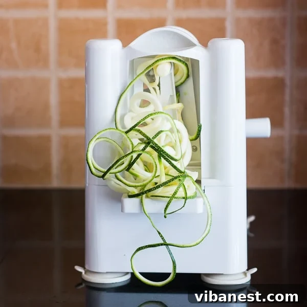 Simple Zucchini Noodles Recipe A bowl of fresh zucchini noodles with ingredients