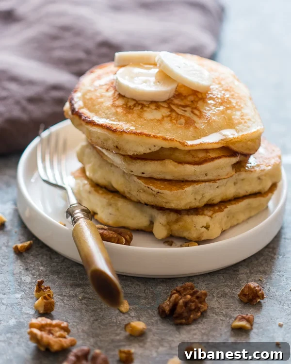 Delicious and Easy Fluffy Banana Pancakes for a Perfect Breakfast Stack of easy fluffy banana pancakes with caramelized banana slices and maple syrup, ready to be served for breakfast