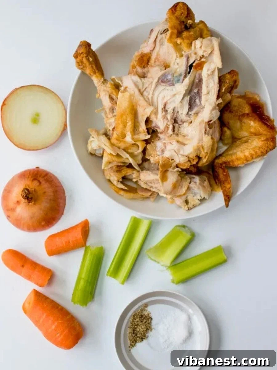 Mastering Homemade Chicken Stock 4 Ingredients to make homemade chicken stock including a raw chicken carcass, onion, carrot, and celery on a cutting board