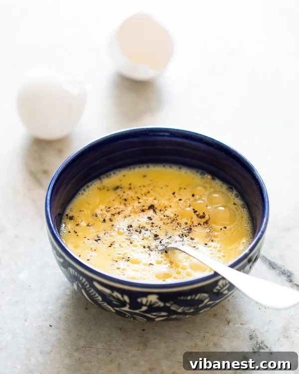 How to make an omelet: Whisking for fluffiness Close-up of a perfectly whisked egg mixture in a bowl