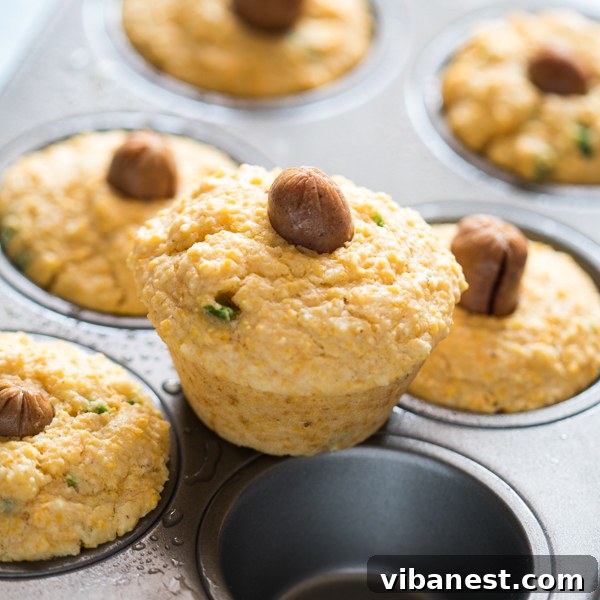 Freshly baked corn dog muffins cooling on a rack