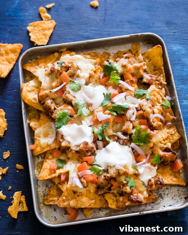 Close-up view of layered BBQ Chicken Nachos before baking