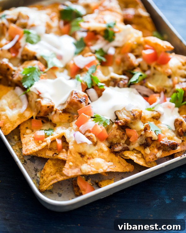 Baked BBQ Chicken Nachos generously topped with fresh ingredients
