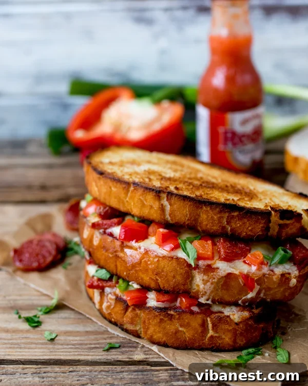 Half-eaten pepperoni pizza grilled cheese showing melted cheese