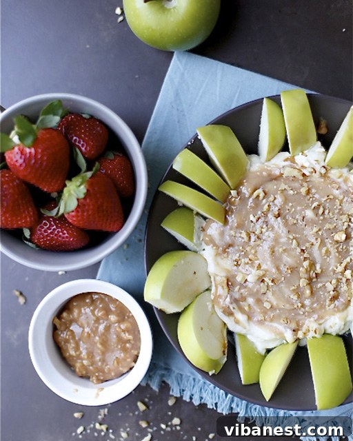 Close-up of creamy Caramel Apple Pecan Cheesecake Dip with a swirl of caramel
