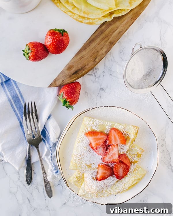 Making Crepes with a Skillet Hand carefully pouring crepe batter into a hot nonstick skillet, beginning the swirling process