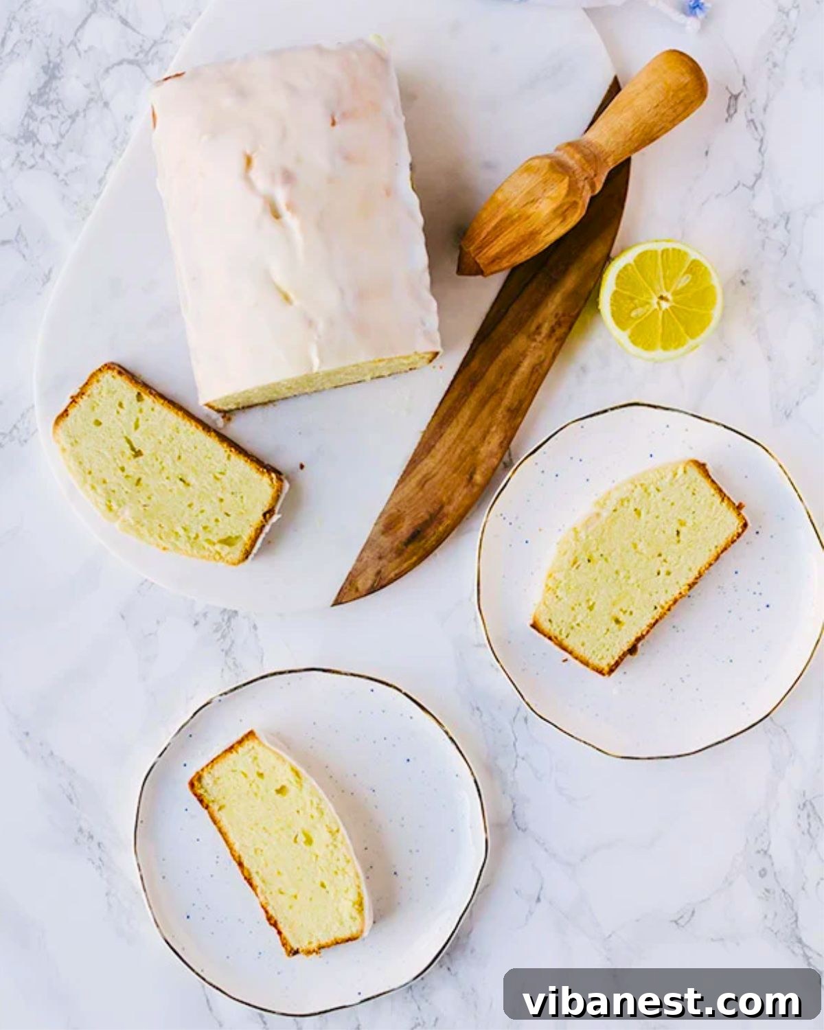 Perfect Starbucks Style Lemon Loaf 4 Slices of glazed Starbucks lemon loaf copycat recipe on white plates