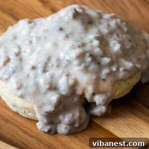 Closeup of homemade sausage breakfast gravy on a biscuit