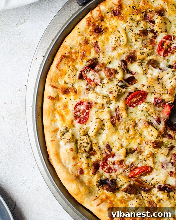 Chicken Bacon Ranch Pizza - Ready to Serve Another perspective of the freshly baked Chicken Bacon Ranch Pizza, with a golden crust, ready to be sliced and served