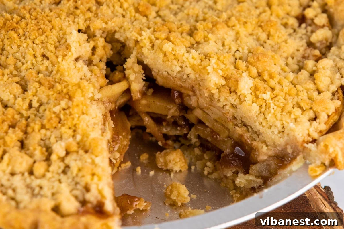 Golden Apple Streusel Pie 5 A slice of Dutch apple pie topped with vanilla ice cream and caramel sauce