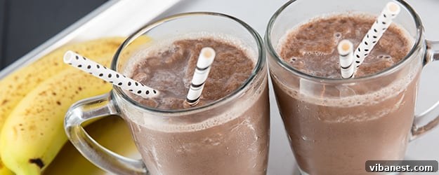 Rich chocolate almond milk freeze in a tall glass, garnished with chocolate shavings, ready to be enjoyed on a warm day.