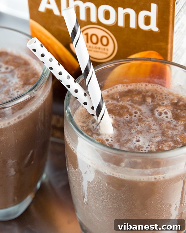 Ready-to-Enjoy Chocolate Almond Milk Freeze A beautifully presented, freshly blended chocolate almond milk freeze served in a tall glass with a straw, ready for a refreshing break.
