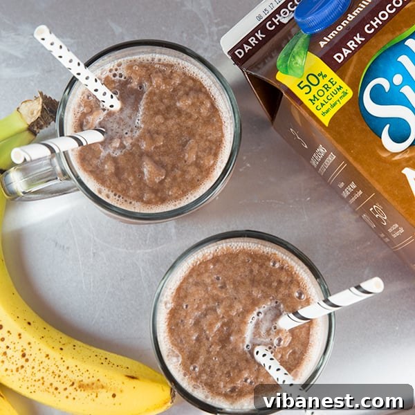 Chocolate Almond Milk Freeze Recipe Card A perfectly blended chocolate almond milk freeze in a glass, with a view of the ingredients list clearly visible for the recipe.