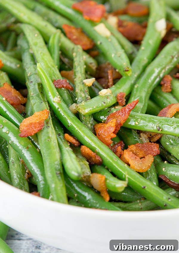how-to-make-green-beans-2.jpg Platter of perfectly cooked green beans with bacon, ready to serve